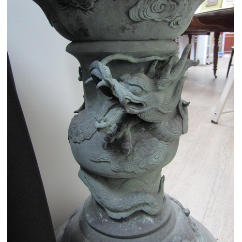 6126 - A bronze Chinese floor standing incense burner with dragon high relief detail on domed footed base, ... 
