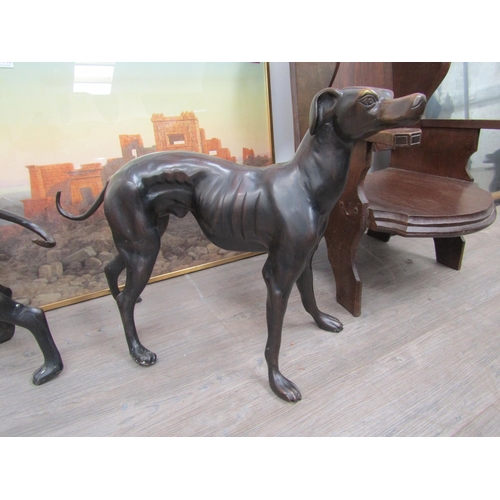 6127 - A pair of hollow cast bronze whippets or greyhounds, unsigned, both approximately 53cm x 67cm