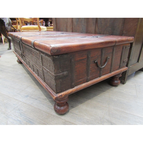 6180 - An Indian hardwood coffee table with storage compartment to the interior, metal strapping and panel ... 