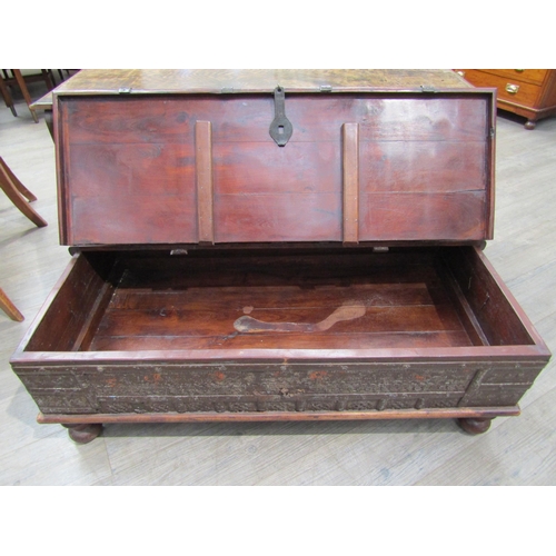 6180 - An Indian hardwood coffee table with storage compartment to the interior, metal strapping and panel ... 
