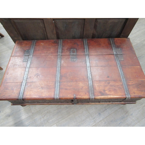 6180 - An Indian hardwood coffee table with storage compartment to the interior, metal strapping and panel ... 