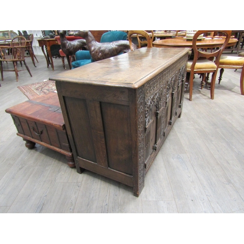 6182 - A late 18th/19th Century oak coffer with carved conjoining rosette borders, the three front panels w... 