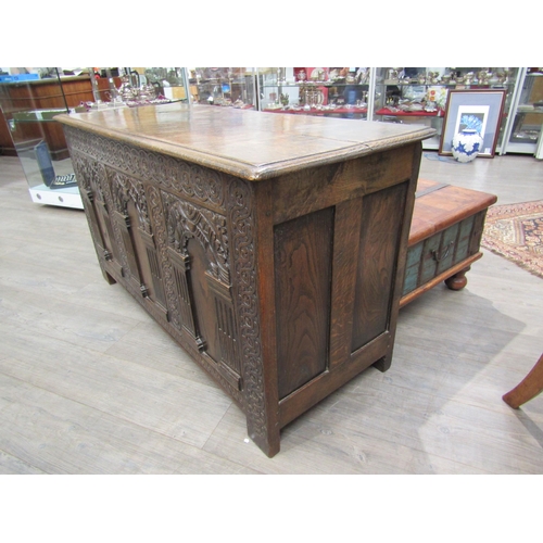 6182 - A late 18th/19th Century oak coffer with carved conjoining rosette borders, the three front panels w... 