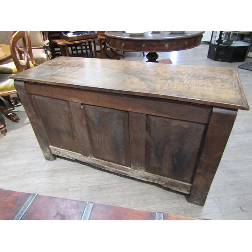 6182 - A late 18th/19th Century oak coffer with carved conjoining rosette borders, the three front panels w... 