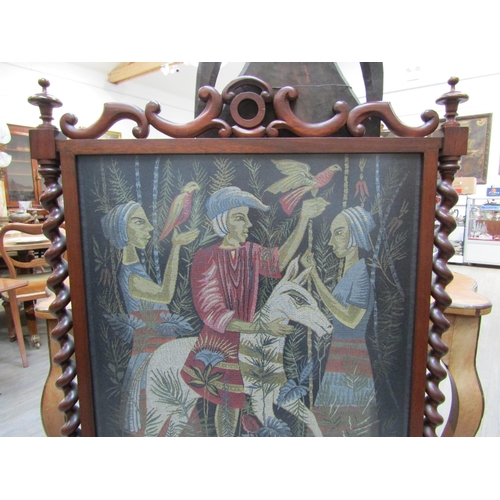 6184 - A rosewood fire screen with barley twist supports and finials on outswept feet, tapestry scene of fi... 