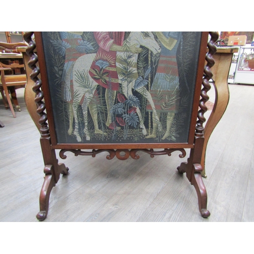 6184 - A rosewood fire screen with barley twist supports and finials on outswept feet, tapestry scene of fi... 