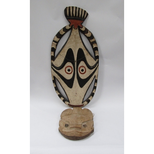 6185 - Two carved masks of two dimensional form, one painted example, 78cm & 29cm tall