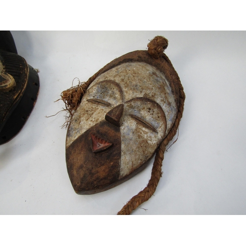 6188 - Two African masks with white painted faces, 33cm & 34cm tall