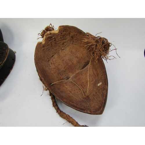 6188 - Two African masks with white painted faces, 33cm & 34cm tall