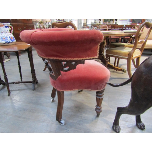 6190 - A 19th Century library tub chair with carved scroll splat, deep pink velour upholstery, turned legs ... 