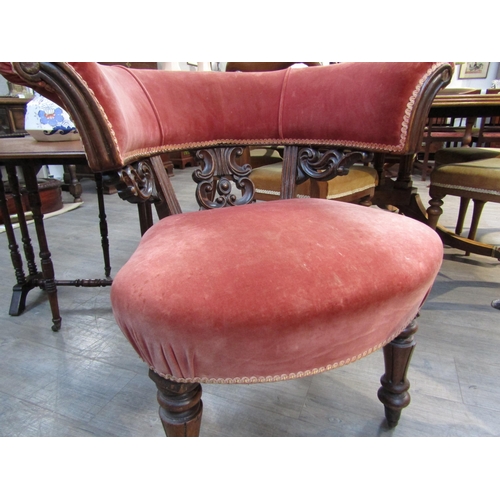 6190 - A 19th Century library tub chair with carved scroll splat, deep pink velour upholstery, turned legs ... 