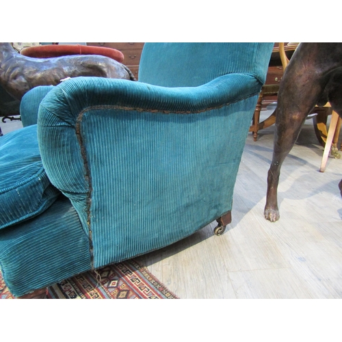 6195 - A Howard and Sons, London Victorian low deep seated armchair on castor feet,  7132/7160 marked on ba... 