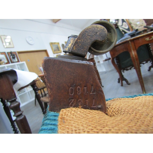 6195 - A Howard and Sons, London Victorian low deep seated armchair on castor feet,  7132/7160 marked on ba... 