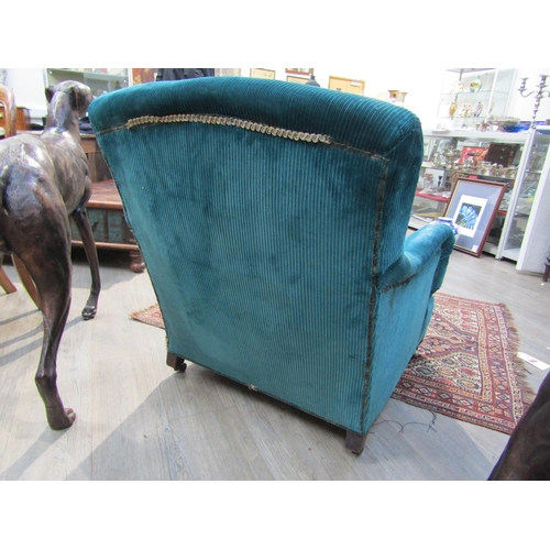 6195 - A Howard and Sons, London Victorian low deep seated armchair on castor feet,  7132/7160 marked on ba... 