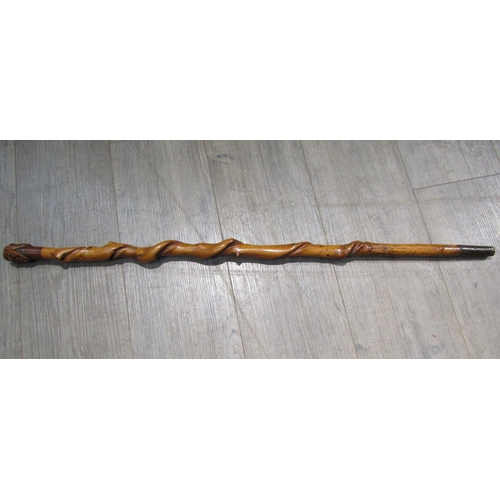 6201 - A knarled twisted wood walking cane with carved double ended mask of a man, 92cm long    (R) £100