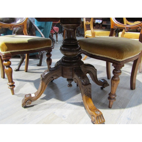 6202 - A Victorian walnut centre table with central diamond form lozenge, turned stem to quatraform base. T... 