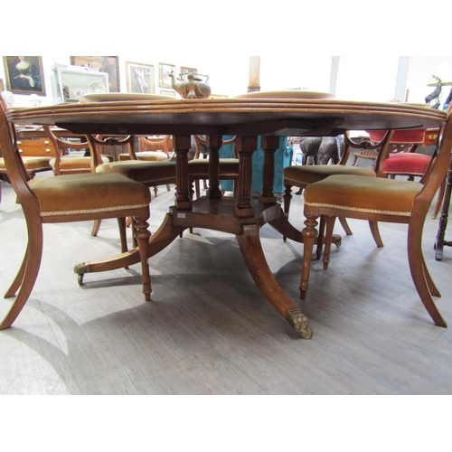 6204 - A Regency style yew wood circular dining table of large proportions. The top 182cm diameter on a fou... 
