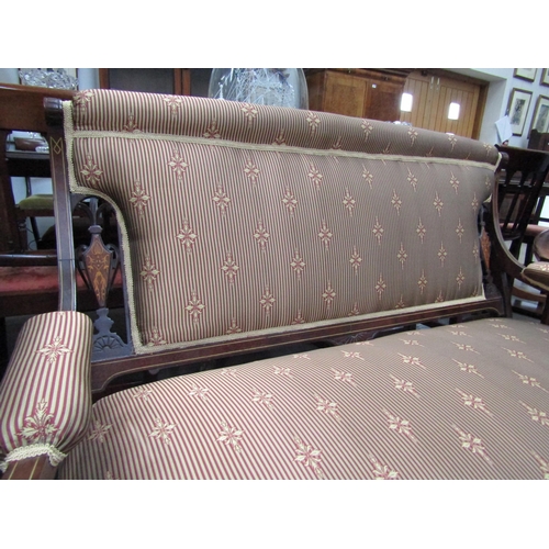 6208 - An Edwardian mahogany satinwood inlaid sofa with overstuffed striped silk upholstery, on turned supp... 