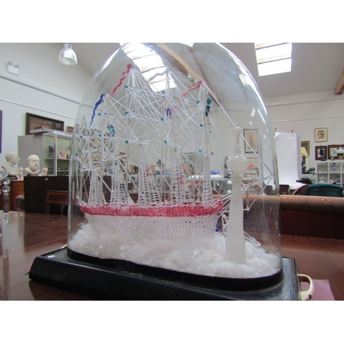 6214 - A spun glass Galleon scene with three smaller vessels and light house, under glass dome, dome measur... 