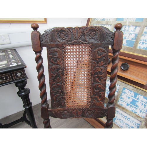 6271 - A Charles II walnut crinoline chair with cane back and seat, barley twist supports all over carved d... 