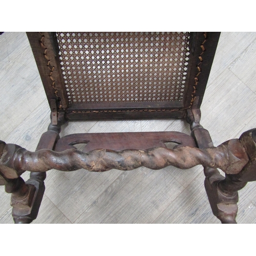 6271 - A Charles II walnut crinoline chair with cane back and seat, barley twist supports all over carved d... 