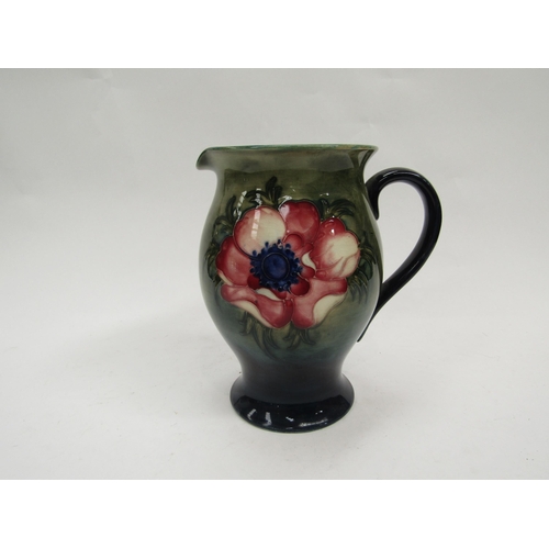 6119 - A Moorcroft Anemone pattern jug on green to blue ground, 19cm tall