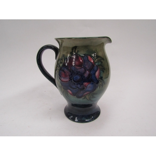 6119 - A Moorcroft Anemone pattern jug on green to blue ground, 19cm tall