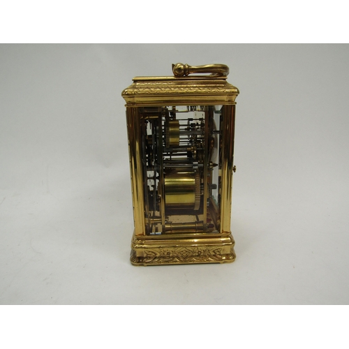 6225 - A French gilded carriage clock in gorge style case, fully engraved, with two keys