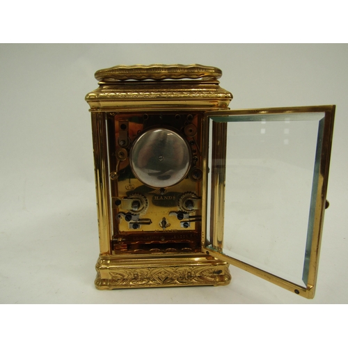 6225 - A French gilded carriage clock in gorge style case, fully engraved, with two keys