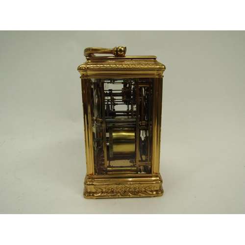6225 - A French gilded carriage clock in gorge style case, fully engraved, with two keys