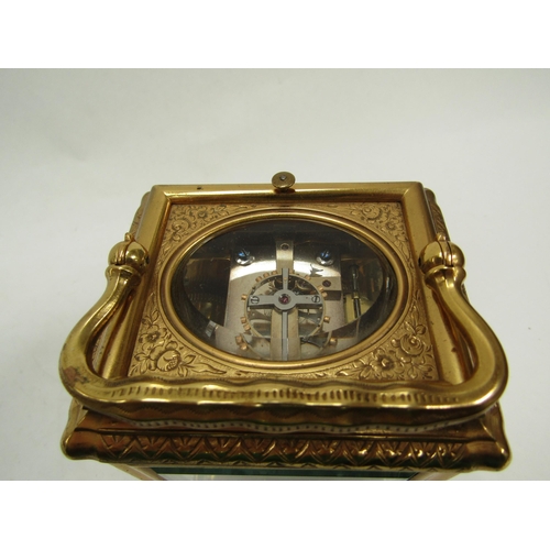 6225 - A French gilded carriage clock in gorge style case, fully engraved, with two keys