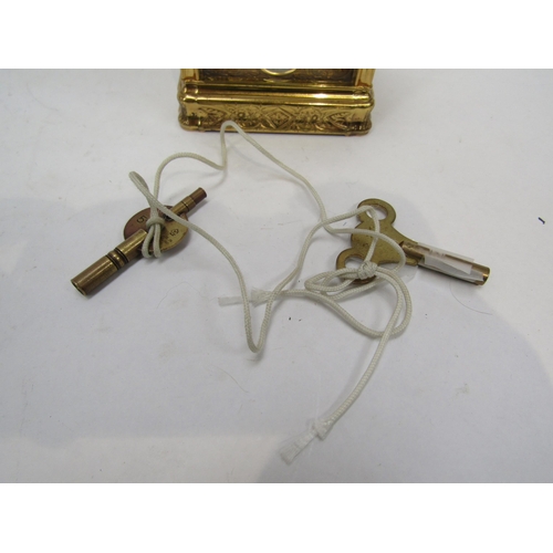 6225 - A French gilded carriage clock in gorge style case, fully engraved, with two keys