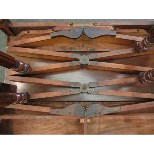 6197 - A Georgian mahogany concertina action extending dining table of rounded square form raised upon six ... 