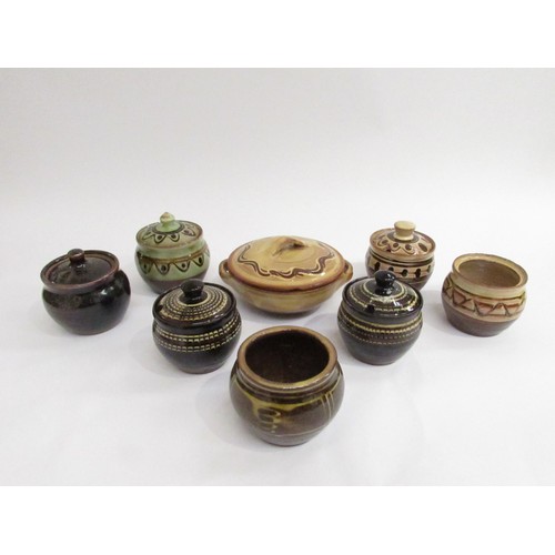 9108 - A collection of studio pottery preserve pots including slipware examples by Sidney Tustin from Winch... 