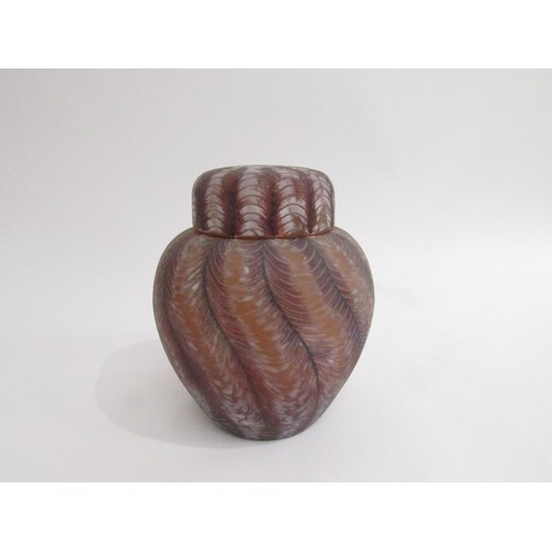 9197 - An Okra glass lidded jar with feathered detail in amethyst and white colours. Incised marks to base.... 