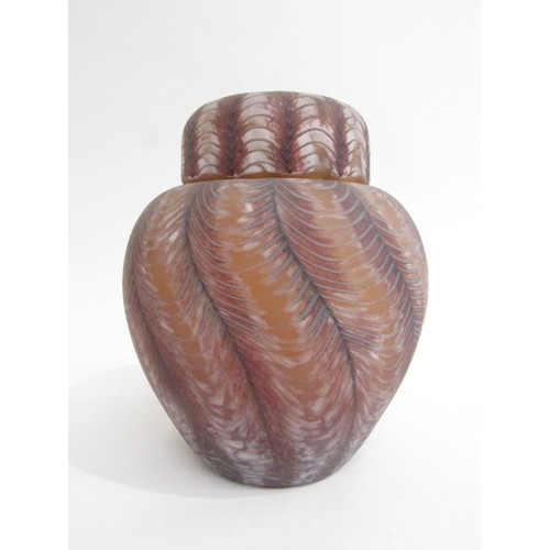 9197 - An Okra glass lidded jar with feathered detail in amethyst and white colours. Incised marks to base.... 