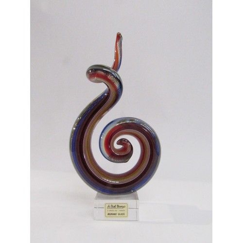 9156 - A Murano Glass sculpture of multi-coloured glass in scroll form on a clear plinth base. Labelled A.D... 