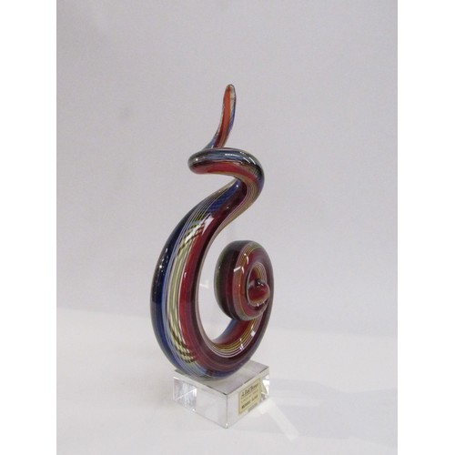 9156 - A Murano Glass sculpture of multi-coloured glass in scroll form on a clear plinth base. Labelled A.D... 