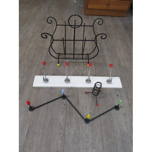 9327 - An Atomic/Sputnik style 1950's candle holder, magazine rack and two 1960's wall mounting coat racks.