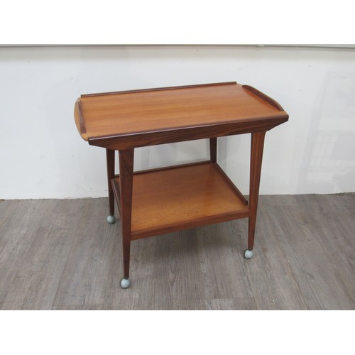 9345 - A Remploy teak two tiered trolley raised on castors, 75cm x 44cm x 69cm high