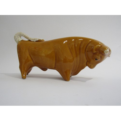 9040 - A Trentham bull designed by Colin Melbourne finished in unusual honey colour.   29cm long x  15cm hi... 