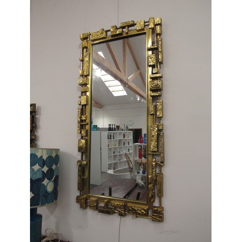 9340 - A Syroco brutalist mirror, mark to reverse frame, overall size 107cm x 50cm     (R) £150