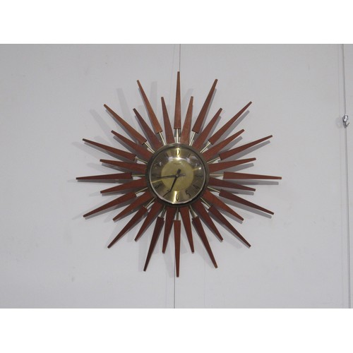 9248 - A Starburst wall clock by Ansley & Wilson with teak and brassed finish, 63.5cm diameter