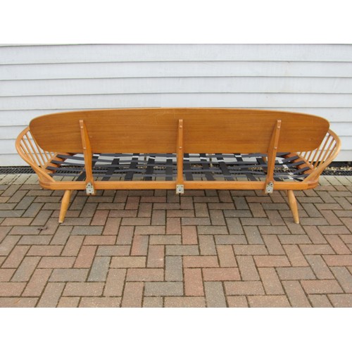 9346 - An Ercol light elm sofa 