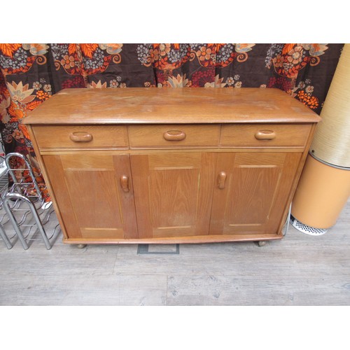 9308 - A Priory oak small side cabinet with three cupboard doors and three drawers 122cm x 51cm x 77cm high... 