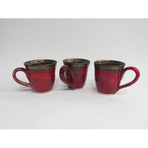 9103 - Judith Swannell - Three studio pottery mugs with artists hand painted marks to base. 9.5cm high