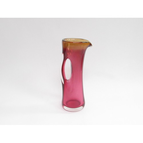 9217 - A Studio art glass large cased Sommerso style jug in cranberry and amber colours, indistinctly signe... 