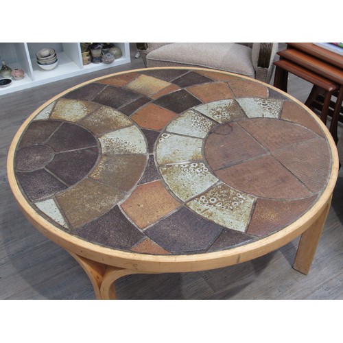 9275 - A Danish circular coffee table with stoneware tiled top by Haslev and laminated ply frame. Marks to ... 