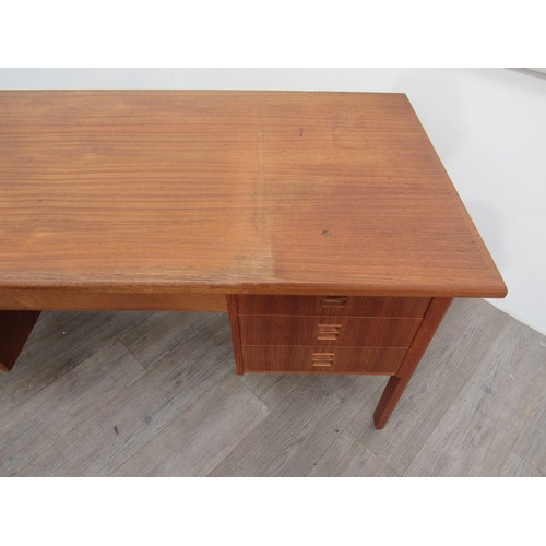 9286 - A Danish teak twin pedestal desk with seven drawers, open 'book shelf' back. 146cm x 76cm x 72.5cm h... 