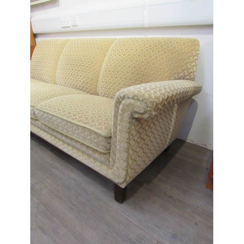 9317 - A 1940's Danish three seater sofa with original pale gold embossed upholstery, raised on dark staine... 